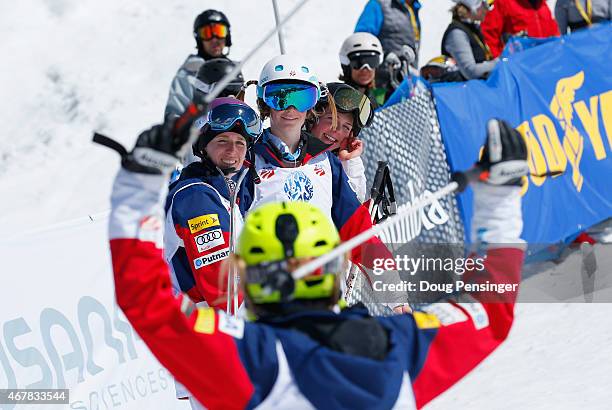 Hannah Kearney reacts after crossing the finish line to win the ladies moguls as Mikaela Matthews, Keaton McCargo and Nessa Dziemian watch at the...