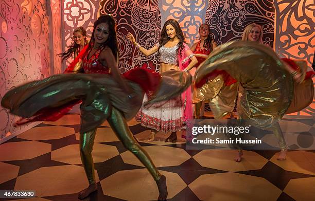 Dancers dance around a waxwork of Katrina Kaif as she attends a photocall to unveil her new wax figure at Madame Tussauds on March 27, 2015 in...