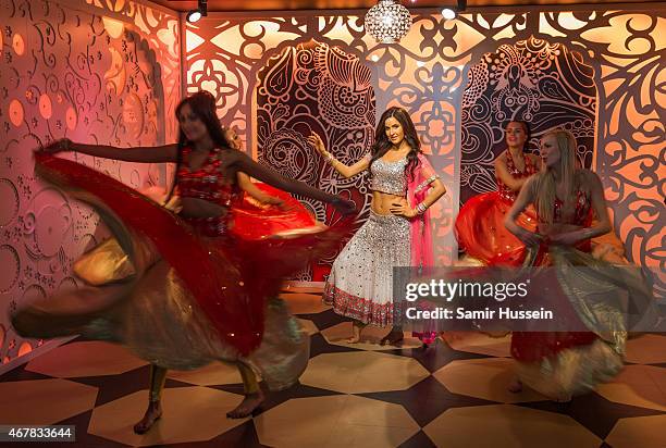 Dancers dance around a waxwork of Katrina Kaif as she attends a photocall to unveil her new wax figure at Madame Tussauds on March 27, 2015 in...