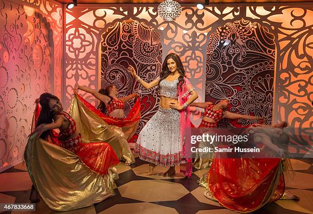 Dancers dance around a waxwork of Katrina Kaif as she attends a photocall to unveil her new wax figure at Madame Tussauds on March 27, 2015 in...