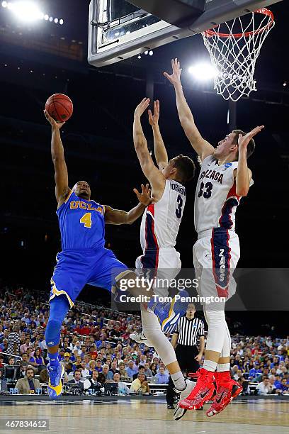 Norman Powell of the UCLA Bruins goes to the basket as Kyle Dranginis and Kyle Wiltjer of the Gonzaga Bulldogs defend during a South Regional...