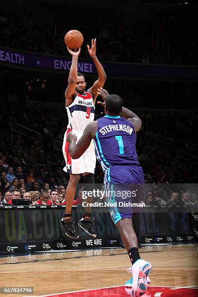 Martell Webster of the Washington Wizards shoots against Lance Stephenson of the Charlotte Hornets during the game on March 27, 2015 at Verizon...