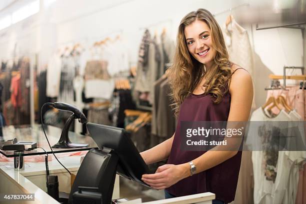 young sales assistant smiling to camera - portrait department store stockfoto's en -beelden