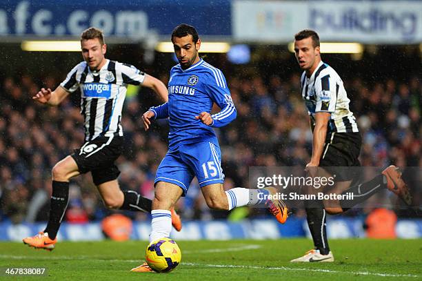 Mohamed Salah of Chelsea holds off the attentions of Paul Dummett and Steven Taylor of Newcastle United during the Barclays Premier League match...