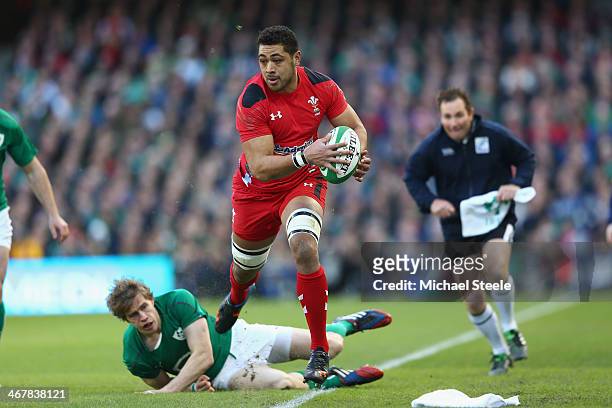 Taulupe Faletau of Wales avoids the challenge of Andrew Trimble of Ireland during the RBS Six Nations match between Ireland and Wales at the Aviva...