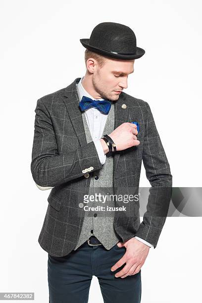 elegant blonde man wearing tweed jacket, bow tie and bowler - suit waistcoat stock pictures, royalty-free photos & images
