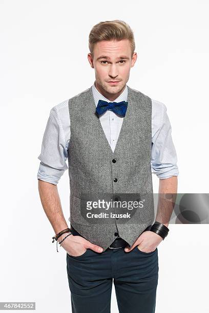 elegant blonde young man wearing tweed vest and bow tie - waistcoat stock pictures, royalty-free photos & images