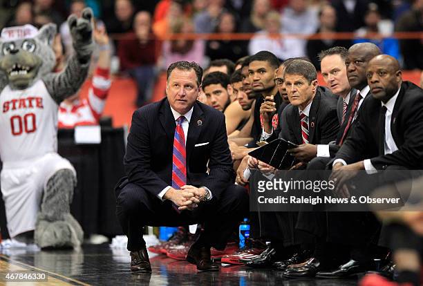 North Carolina State head coach Mark Gottfried watches during the first half against Louisville in an NCAA Tournament East Region Sweet 16 game at...
