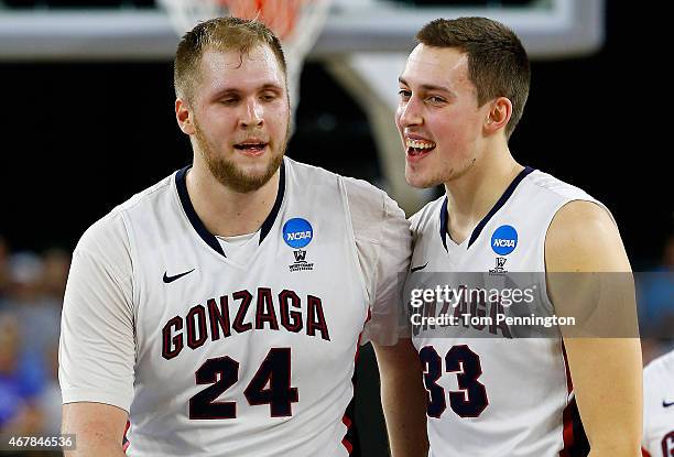 Przemek Karnowski celebrates with Kyle Wiltjer of the Gonzaga Bulldogs against the UCLA Bruins during a South Regional Semifinal game of the 2015...