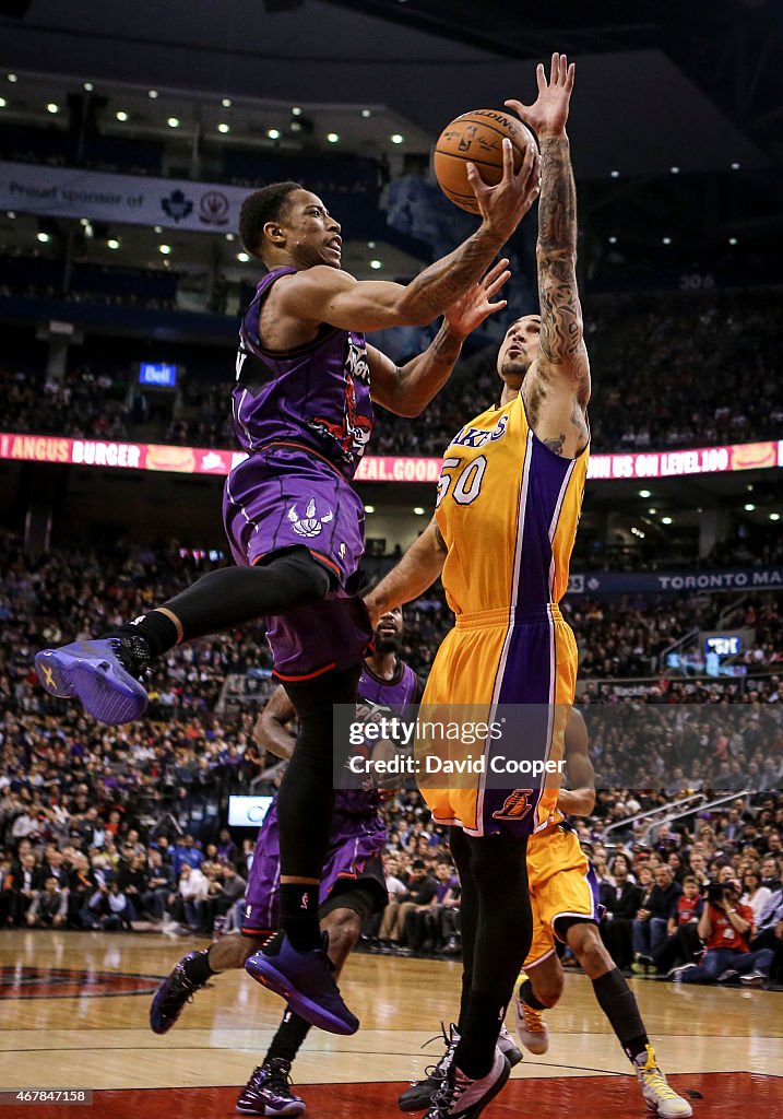 DeMar DeRozan (10) of the Toronto Raptors goes up and around Robert Sacre (50) of the Los Angeles Lakers