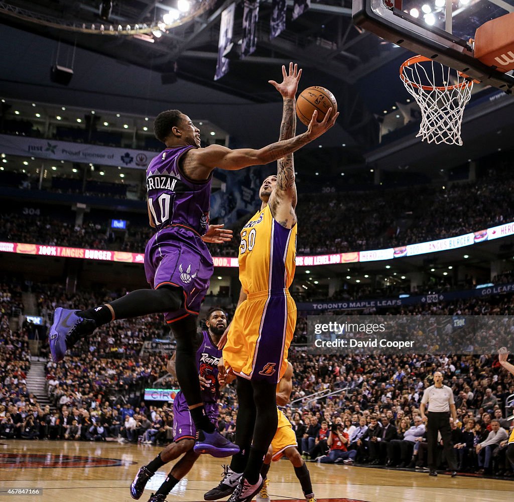 DeMar DeRozan (10) of the Toronto Raptors goes up and around Robert Sacre (50) of the Los Angeles Lakers