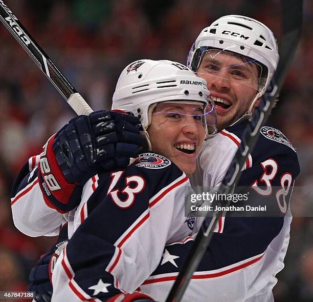 Cam Atkinson of the Columbus Blue Jackets gets a hug from teammate Boone Jenner after s coring a goal in the first period against the Chicaho...