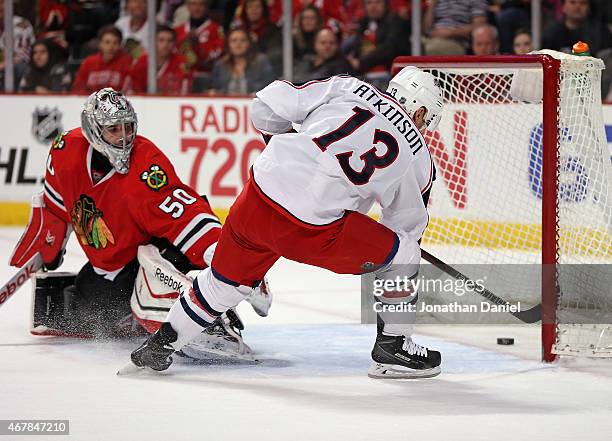 Cam Atkinson of the Columbus Blue Jackets scores his second goal of the first period against Corey Crawford of the Chicago Blackhawks at the United...