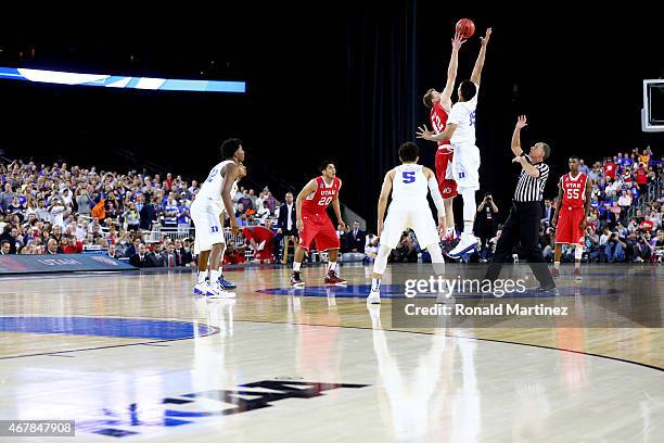 Jakob Poeltl of the Utah Utes and Jahlil Okafor of the Duke Blue Devils take the opening jump ball during a South Regional Semifinal game of the 2015...