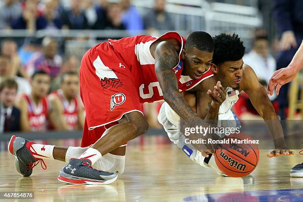 Delon Wright of the Utah Utes and Quinn Cook of the Duke Blue Devils dive for a loose ball during a South Regional Semifinal game of the 2015 NCAA...