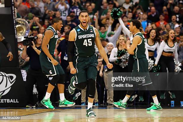 Denzel Valentine of the Michigan State Spartans celebrates after defeating the Oklahoma Sooners 62 to 58 during the East Regional Semifinal of the...