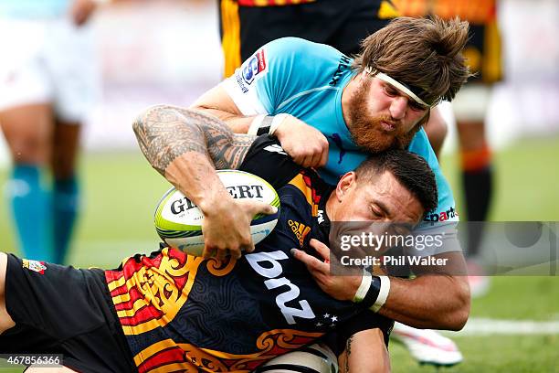 Sonny Bill Williams of the Chiefs is tackled by Boom Prinsloo of the Cheetahs during the round seven Super Rugby match between the Chiefs and the...