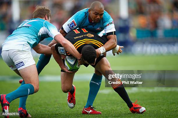 Tom Marshall of the Chiefs is tackled during the round seven Super Rugby match between the Chiefs and the Cheetahs at Waikato Stadium on March 28,...