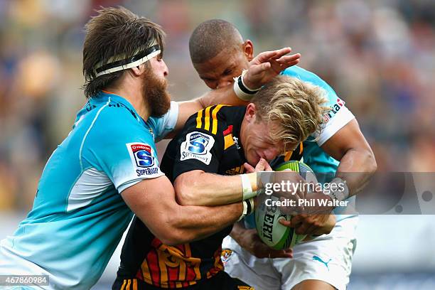 Damian McKenzie of the Chiefs is tackled during the round seven Super Rugby match between the Chiefs and the Cheetahs at Waikato Stadium on March 28,...