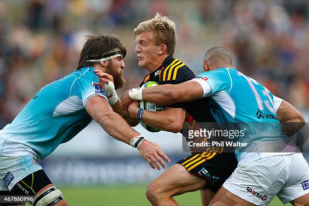 Damian McKenzie of the Chiefs is tackled during the round seven Super Rugby match between the Chiefs and the Cheetahs at Waikato Stadium on March 28,...