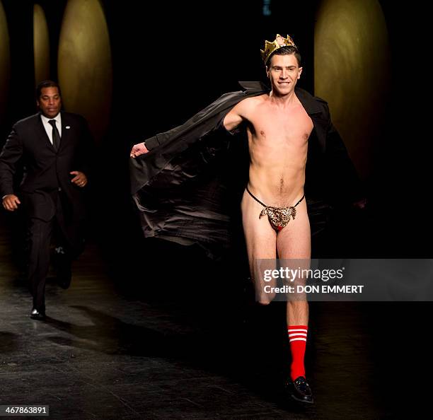 Flasher runs from security guards during as show of designs by Prabal Gurung during the Mercedes-Benz Fashion Week Fall/Winter 2014 shows on February...