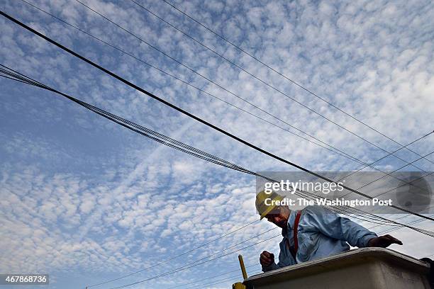 Pepco employee, James Tarantella climbs out of a bucket after fixing a blown fuse on a power outage call on Monday August 13, 2012 in Rockville, MD....