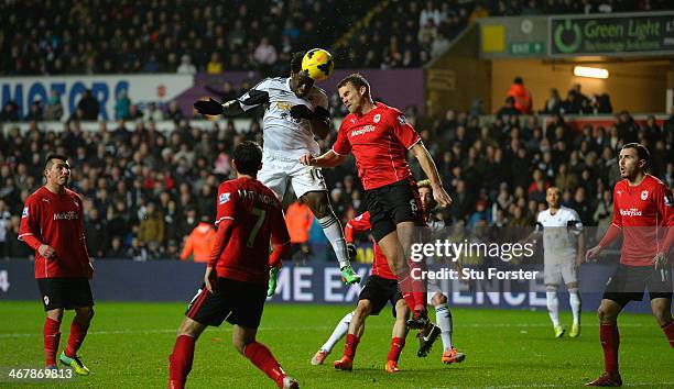 Swansea striker Wilfried Bony beats Ben Turner to score the third goal during the Barclays Premier League match between Swansea City and Cardiff City...