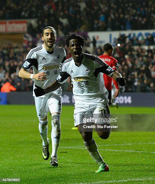 Swansea striker Wilfried Bony celebrates with Chico Flores after scoring the third goal during the Barclays Premier League match between Swansea City...