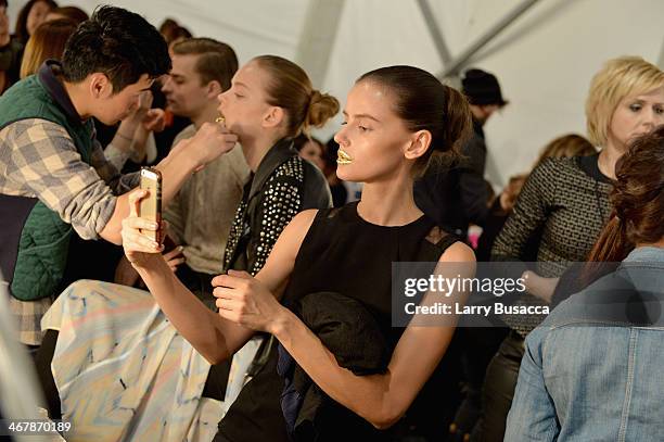 Models prepare backstage at the Son Jung Wan fashion show during Mercedes-Benz Fashion Week Fall 2014 at The Pavilion at Lincoln Center on February...