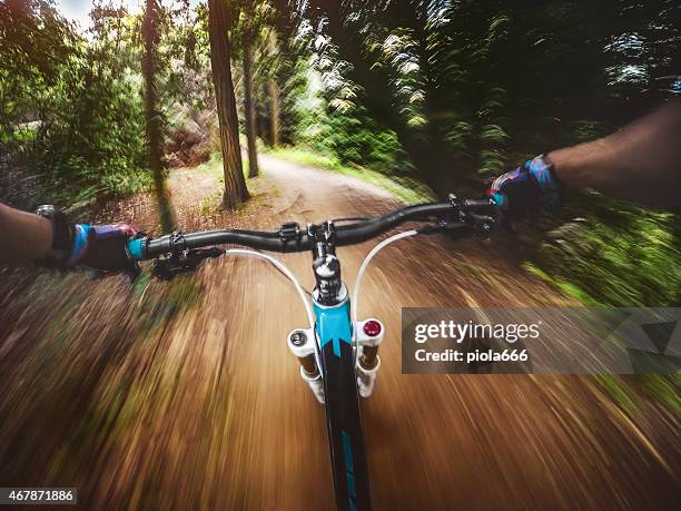 mountain bike: riding a fast single trail in the forest - extreme angle stock pictures, royalty-free photos & images