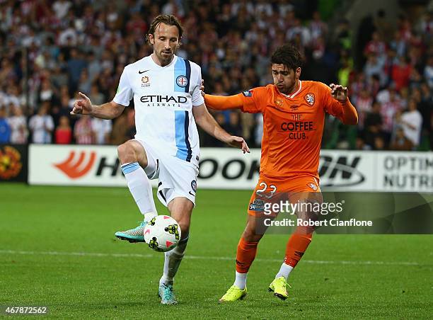 Josh Kennedy of Melbourne City controls the ball in front of Dimitri Petratos of the Brisbane Roar during the round 23 A-League match between...