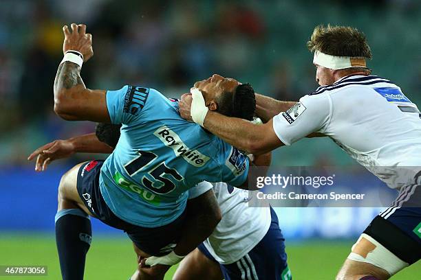 Israel Folau of the Waratahs is tackled high during the round seven Super Rugby match between the Waratahs and the Blues at Allianz Stadium on March...