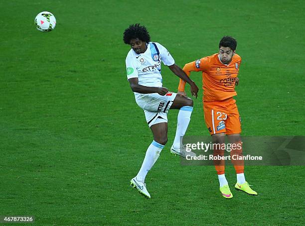 Kew Jaliens of Melbourne heads the ball away from Dimitri Petratos of the Brisbane Roar during the round 23 A-League match between Melbourne Victory...