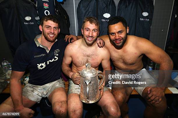 Tom Wood, Chris Robshaw and Billy Vunipola of England pose in the dressing room with The Calcutta Cup after victory in the RBS Six Nations match...