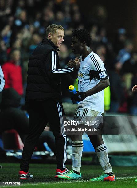 New head coach Garry Monk celebrates with goalscorer Wilfried Bony after the Barclays Premier League match between Swansea City and Cardiff City at...