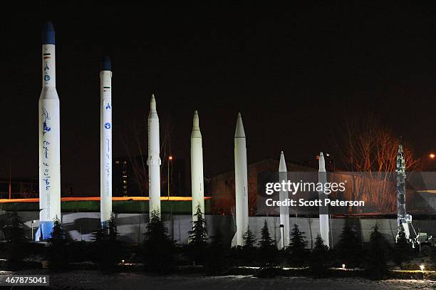 Full-size replicas of each of Iran's space rockets and ballistic missiles are displayed at night on the grounds of the Museum of Holy Defense and...