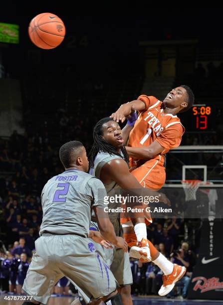 Guard Isaiah Taylor of the Texas Longhorns makes a pass against forward D.J. Johnson of the Kansas State Wildcats during the first half on February...