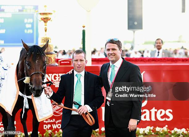 Former England international footballer Michael Owen and trainer Tom Dascombe pose with Brown Pather after winning Dubai Gold Cup during the Dubai...