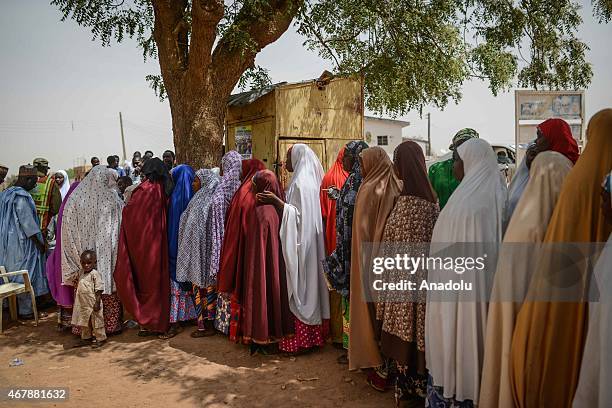 Nigerians wait in the queue to vote at Tudun Wada polling station in Daura district of Katsina, Nigeria on March 28, 2015. Security has been beefed...