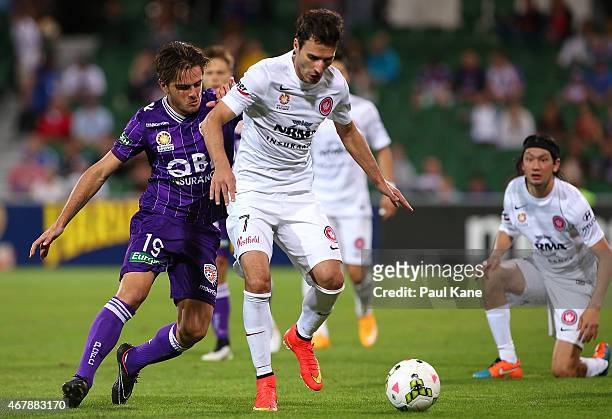 Josh Risdon of the Glory and Labinot Haliti of the Wanderers contest for the ball during the round 23 A-League match between Perth Glory and the...