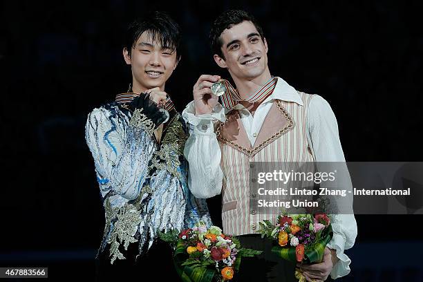 Second place winner Yuzuru Hanyu of Japan, First place winner Javier Fernandez of Spain pose on the podium after the medals ceremony of the Ice...