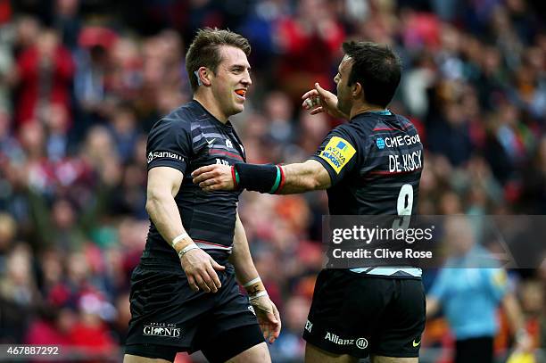 Chris Wyles of Saracens is congratulated by teammate Neil de Kock of Saracens after scoring his team's first try during the Aviva Premiership match...