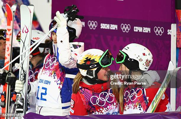 Justine Dufour-Lapointe and Chloe Dufour-Lapointe of Canada celebrate as Aiko Uemura of Japan looks on after the Ladies' Moguls Final during day 1 of...