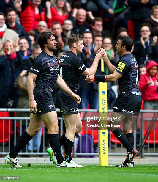 Chris Ashton of Saracens is congratulated by teammate Neil de Kock of Saracens after scoring his team's second try during the Aviva Premiership match...