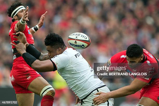 Toulouse's Samoan lock Isofe Tekori vies with RC Toulon's centre Maxime Mermoz and RC Toulon's lock Romain Taofifenua during the French Top 14 rugby...