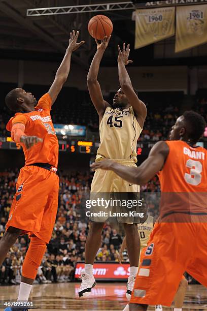 Arnaud William Adala Moto of the Wake Forest Demon Deacons puts up a shot against Baye Moussa Keita of the Syracuse Orange at Lawrence Joel Coliseum...