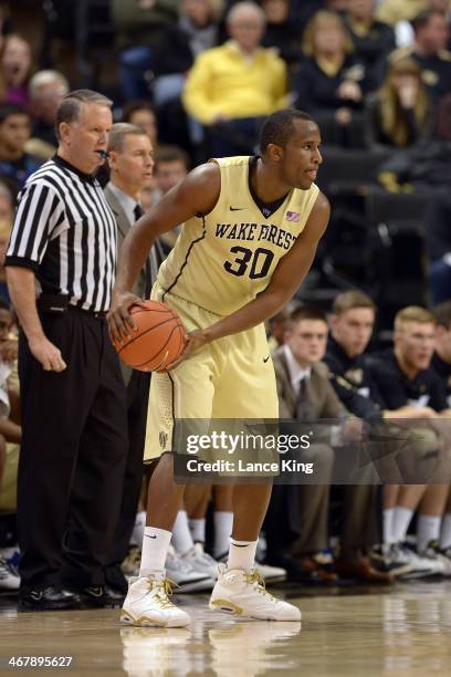 Travis McKie of the Wake Forest Demon Deacons controls the ball against the Syracuse Orange at Lawrence Joel Coliseum on January 29, 2014 in...