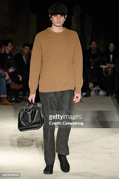 Model walks the runway at the N.Hoolywood Autumn Winter 2014 fashion show during New York Fashion Week on February 7, 2014 in New York, United States.