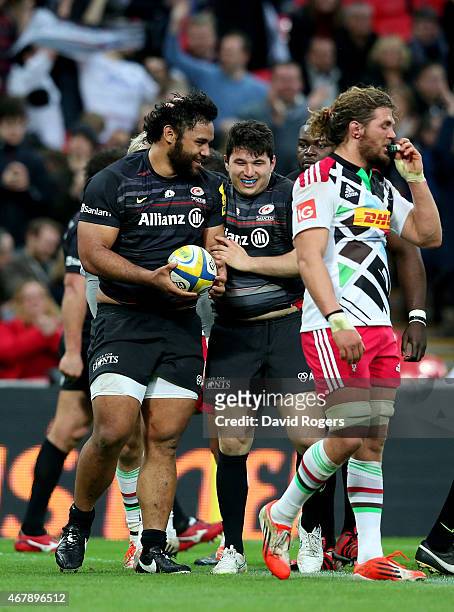 Billy Vunipola of Saracens is congratulated by teammate Scott Spurling after scoring his team's fifth and final try during the Aviva Premiership...