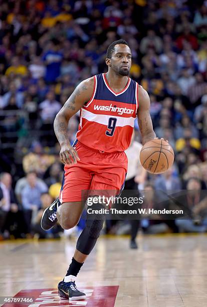 Martell Webster of the Washington Wizards dribbles the ball up court against the Golden State Warriors at ORACLE Arena on March 23, 2015 in Oakland,...